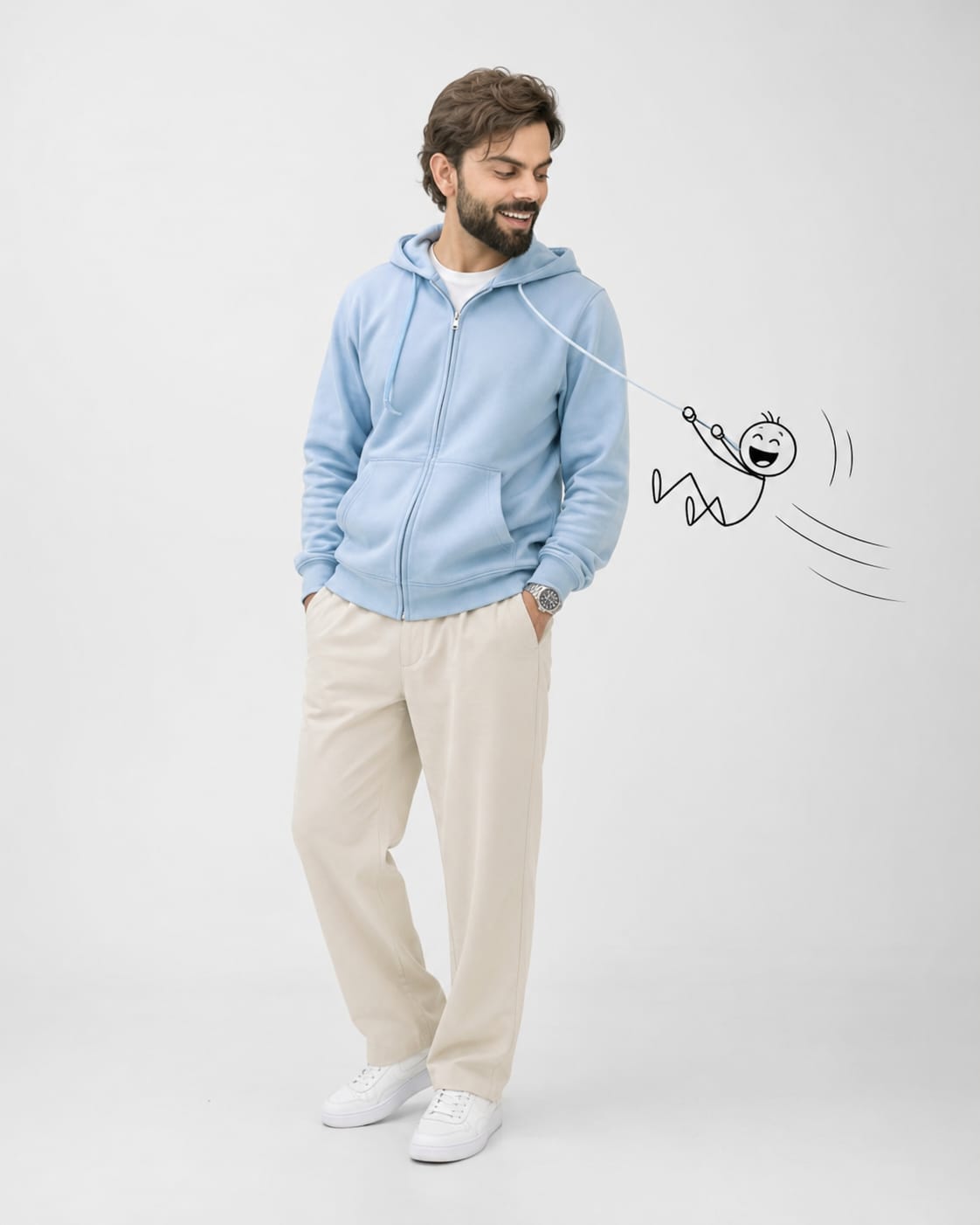 Man in pastel blue hoodie laughing at black outline doodle character sliding down hoodie drawstring like zipline