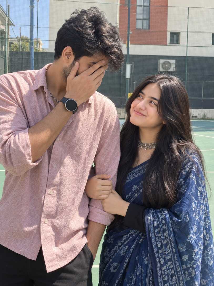 Romantic couple prompt court pose photo, boy covering face with hand, girl in navy saree looking up, chatgpt couple photo prompt example