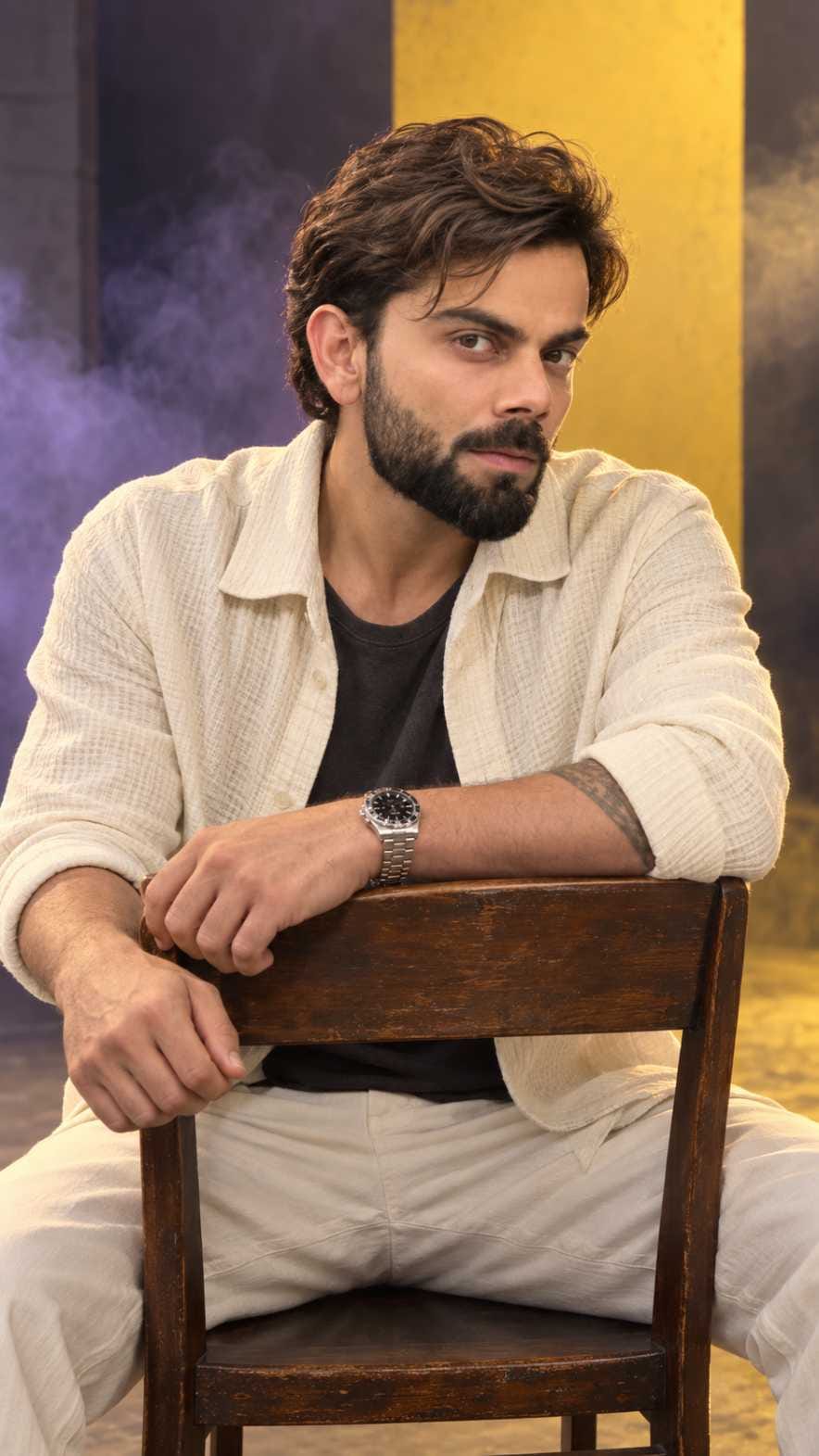 Man sitting on a reversed wooden chair in a cinematic studio AI portrait with yellow panel and purple smoke